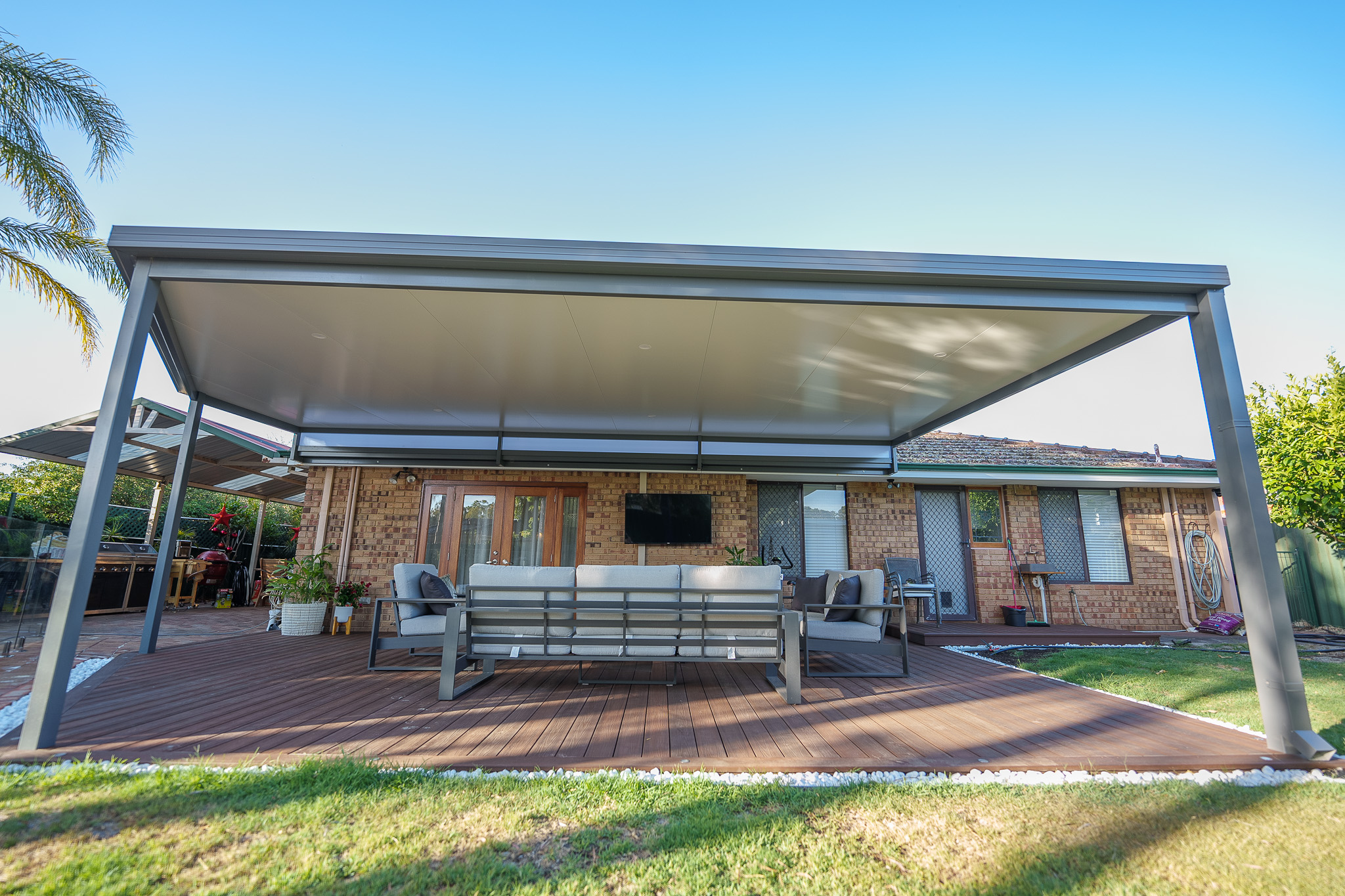 Hanging TV to create outdoor movie watching backyard oasis area